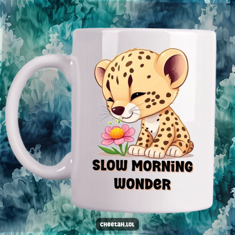 Funny cheetah cub mug showing a cub curiously sniffing a colorful flower with wide-eyed wonder and delight.