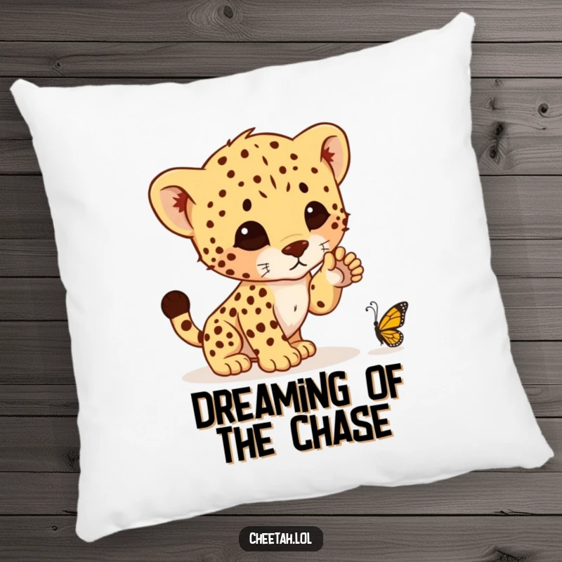 Funny pillow featuring a charming cheetah cub mid-pounce, playfully targeting a tiny butterfly, ideal for adding humor to any room.