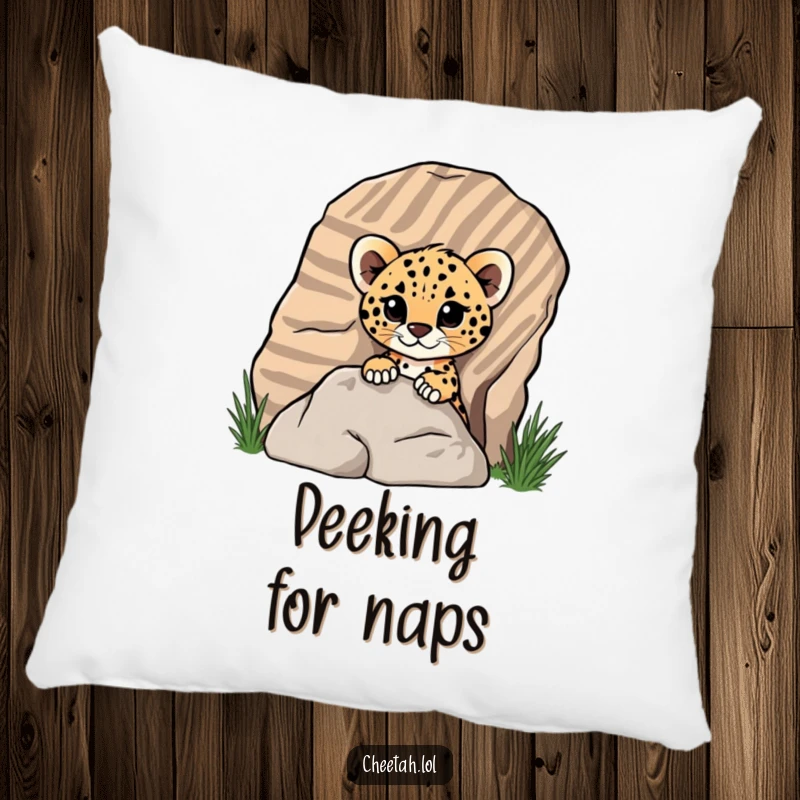 Funny cheetah cub peeking from behind a rock on a plush pillow, depicting playful surprise for screen reader users.