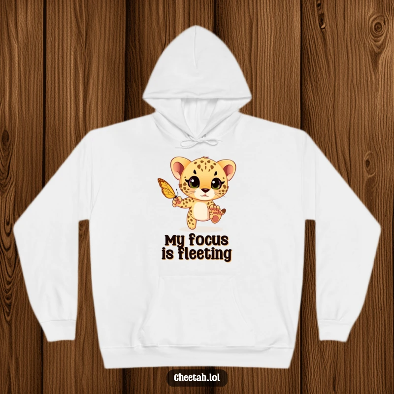 Funny cheetah cub playfully chasing a butterfly with wide eyes, a cozy and humorous design on a warm hoodie for comfort.