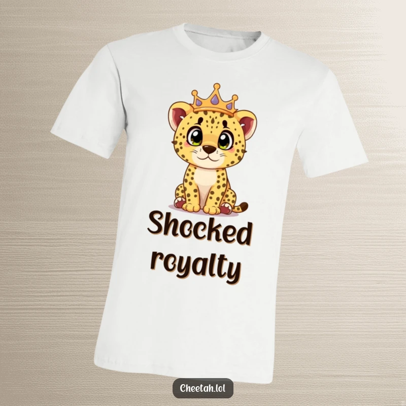 Funny cheetah cub t-shirt featuring a cub wearing a crown, looking surprised with wide, curious eyes, embodying royal wonder.