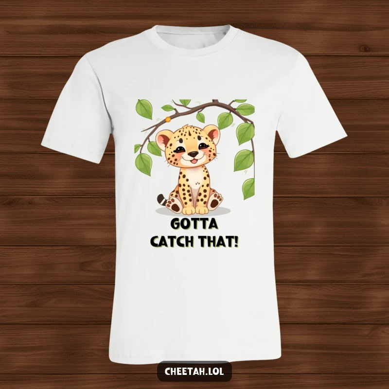 Funny cheetah cub t-shirt featuring a cute cub gleefully batting at a dangling vine, embodying playful jungle exploration and innocence.