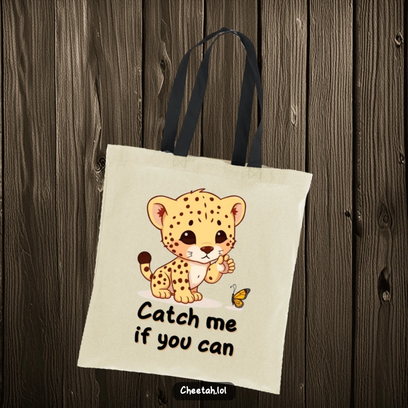Funny tote bag showcasing a cute cheetah cub's determined, yet comical, attempt to pounce on a tiny butterfly, ready for shopping adventures.